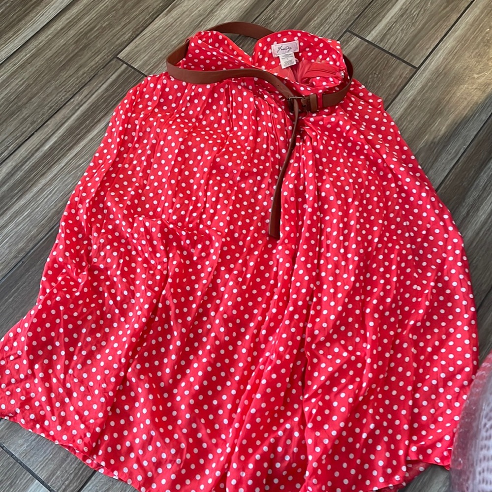 Red and white poka dot skirt with brown belt.